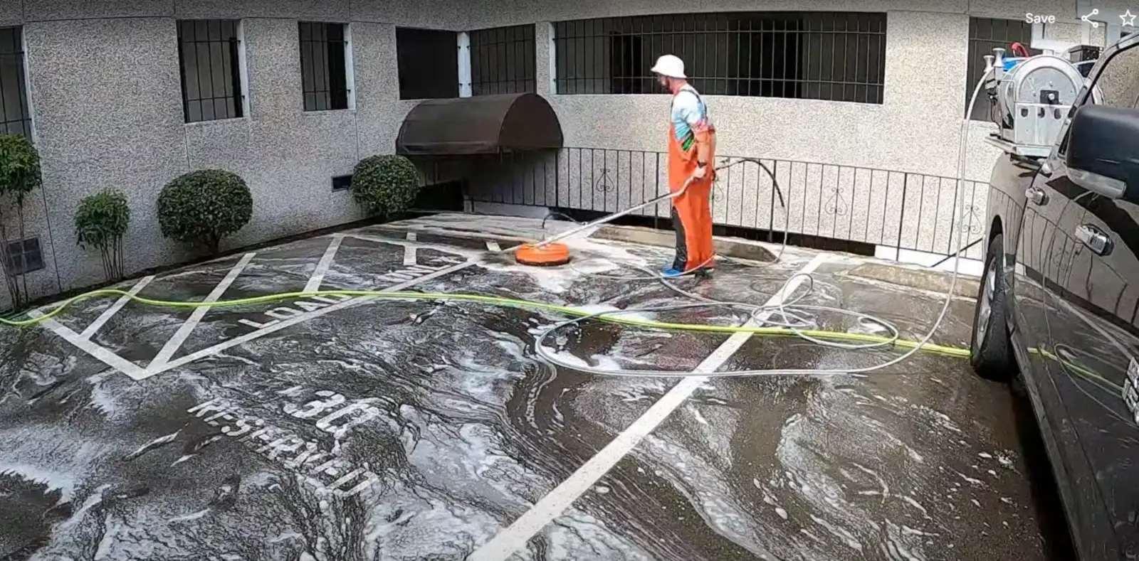 Deep Water technician surface cleaning the garage court of a multi-story apartment building