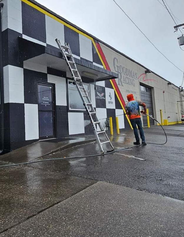 Deep Water technician washing a commercial building exterior in Seattle