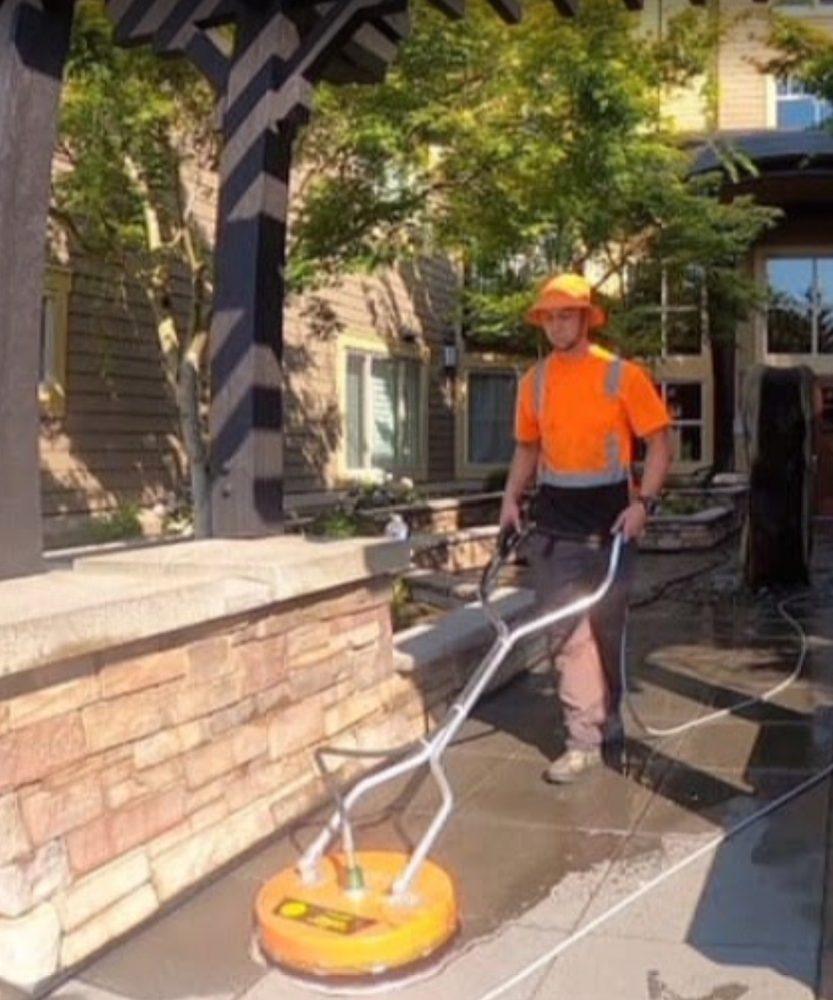 Technician surface cleaning a commercial courtyard walkway in Bellevue