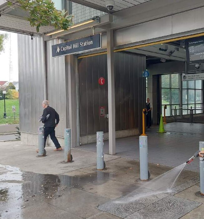 Deep Water technician pressure washing a Capitol Hill entry plaza