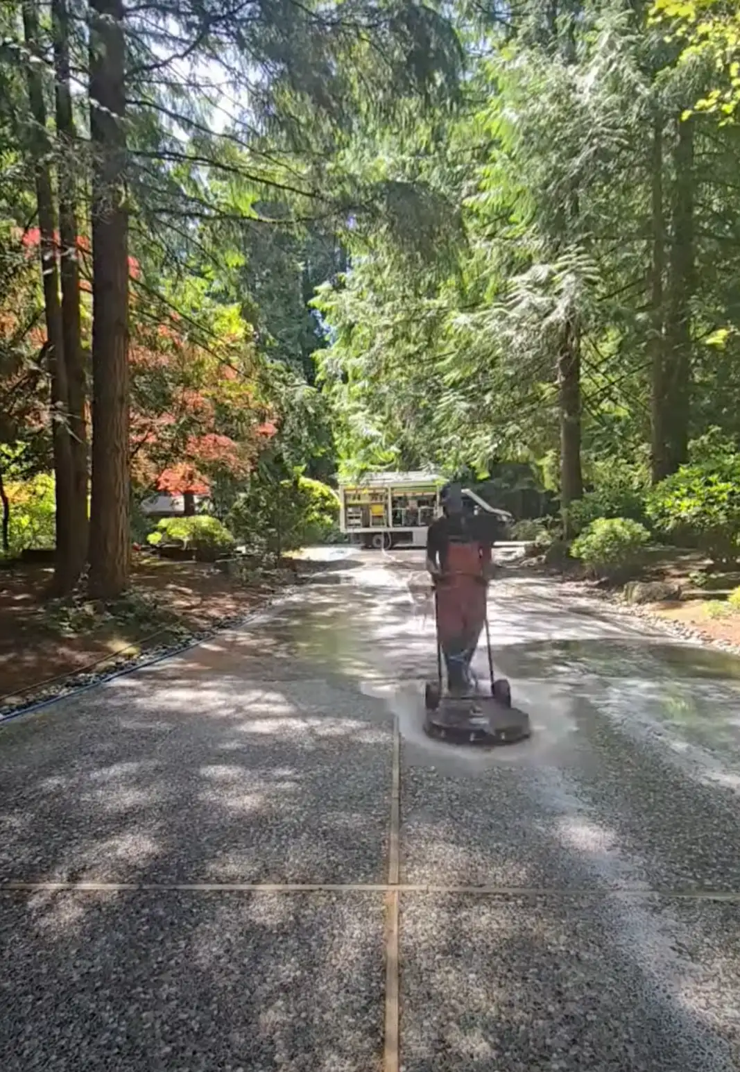 Deep Water technician cleaning a long wooded driveway on Mercer Island