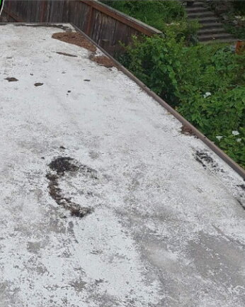 Flat roof stained with dirt and debris