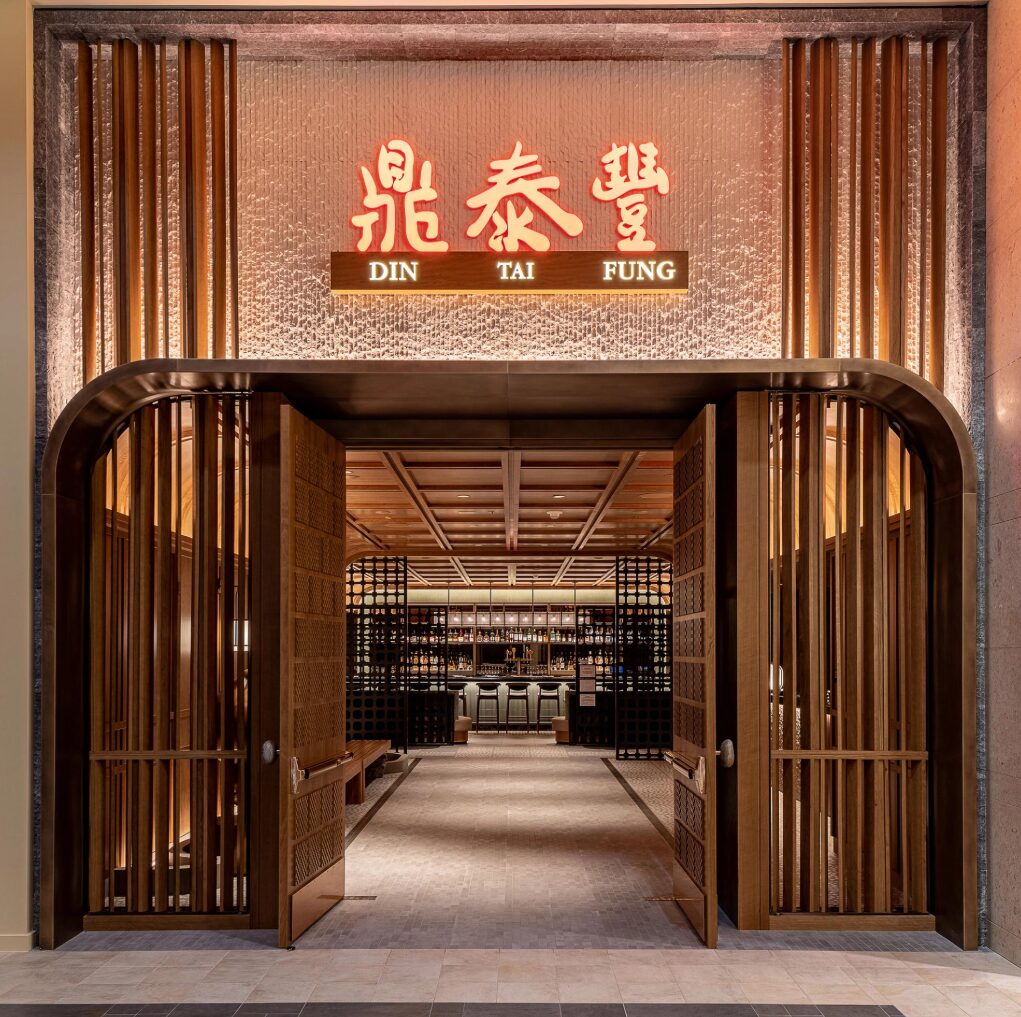 Bellevue restaurant entrance with wood paneling and a lit sign