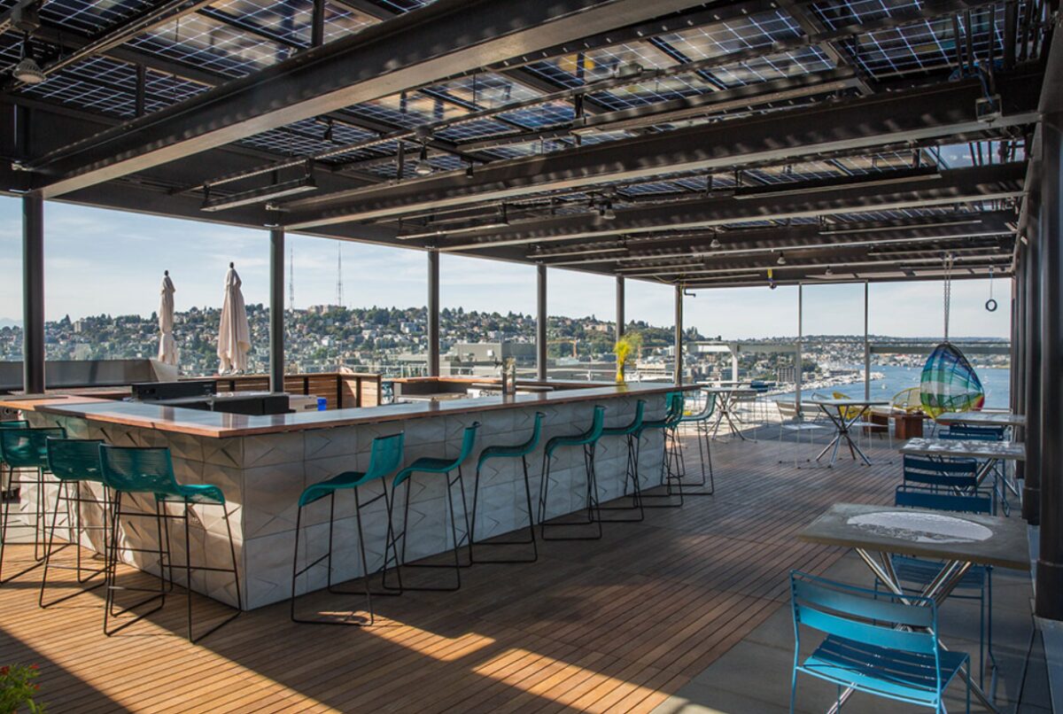 Rooftop restaurant deck with glass railings overlooking the Seattle waterfront