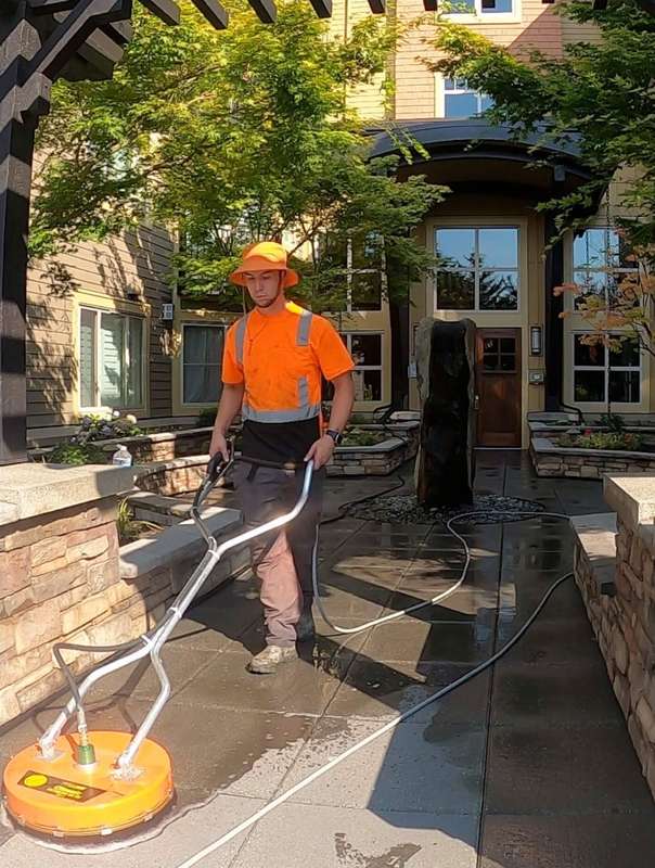 Deep Water technician surface cleaning a building entry walkway