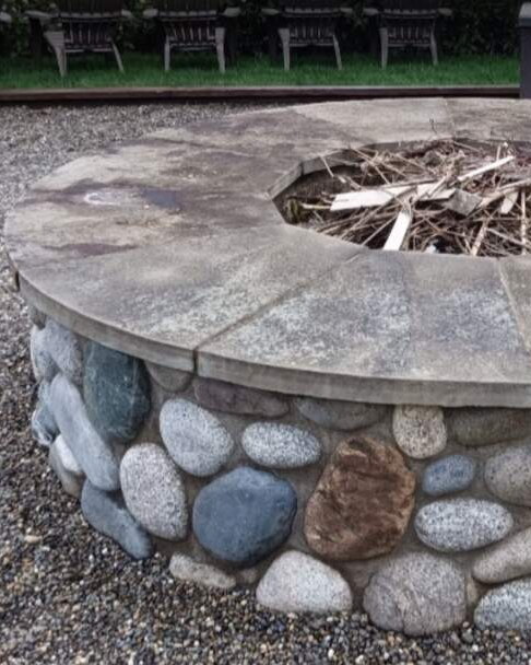 Stone fire pit and gravel dark with grime