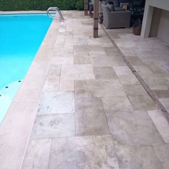 Travertine pool deck clean and bright after pressure washing