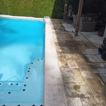 Travertine pool deck stained and dark before cleaning