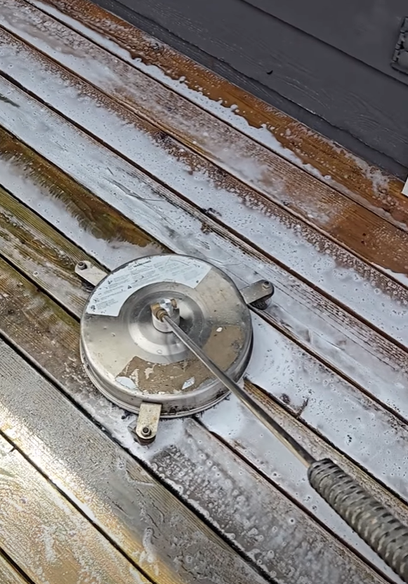 Surface cleaner restoring a weathered wood deck in Seattle
